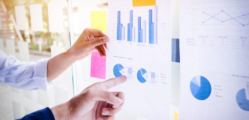 Businessman making presentation with his colleagues and business Businessman making presentation with his colleagues and business strategy digital layer effect at the office as concept.